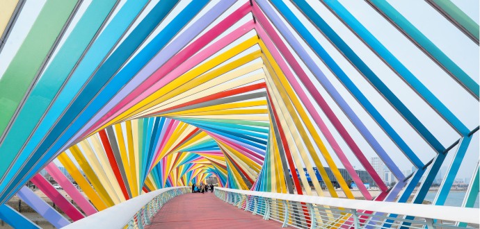 People walking on a colourful bridge