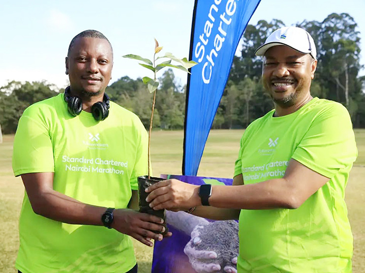 Nairobi Marathon representatives holding tree sappling