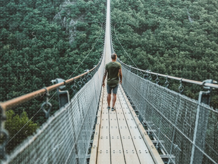 A person walking over a bridge