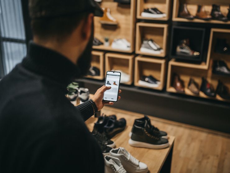 Man looking at an online shoe store on his mobile